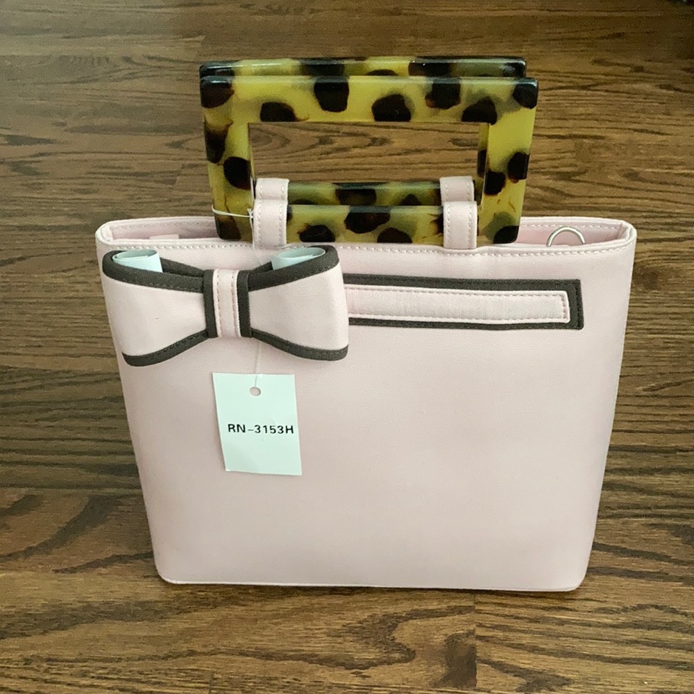 Pink purse with tortoise shell handles